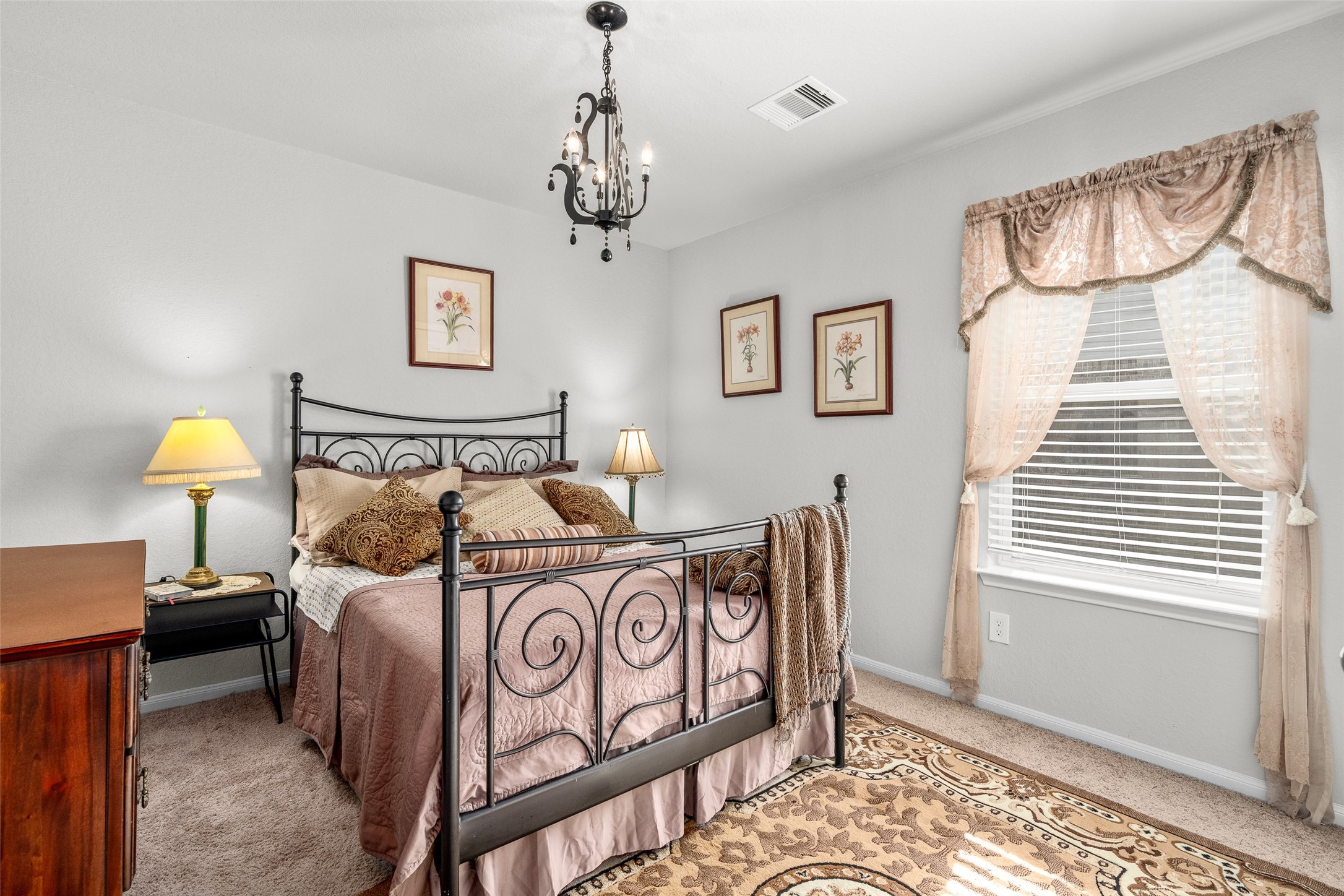 4518 Antero Court Rosenberg, TX 77471 - Photo 9 of 33 a bedroom with a bed and a chandelier
