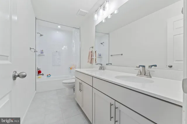 a spacious bathroom with a bathtub shower sink double and mirror