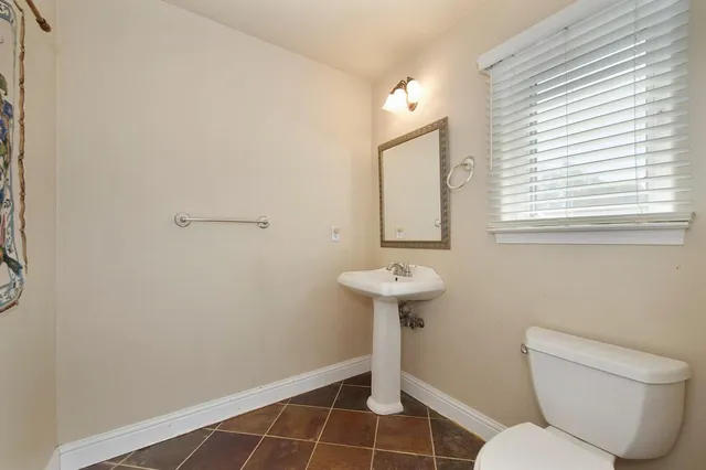 a open kitchen with stainless steel appliances granite countertop a sink dishwasher and a dining table with wooden floor