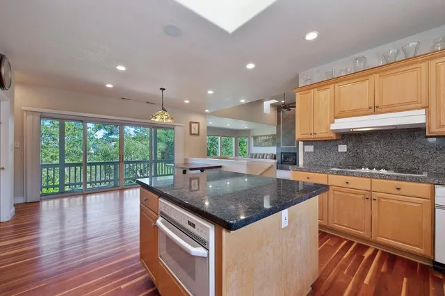 an empty room with a window and a kitchen