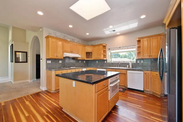 a bedroom with a bed window and flat screen tv