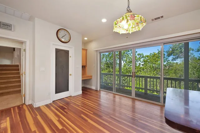 a bedroom with a bed chandelier and a window