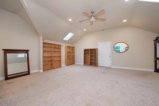 a bathroom with a granite countertop sink a mirror and a shower