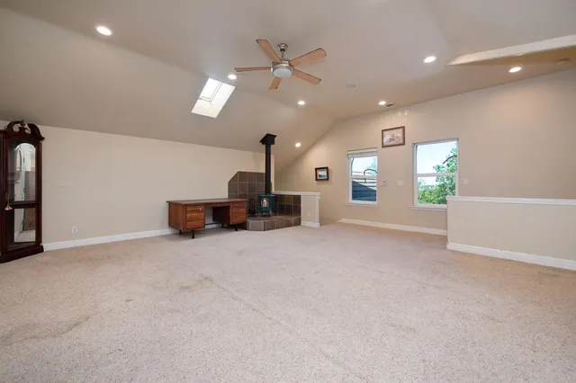 an empty room with a ceiling fan and a window