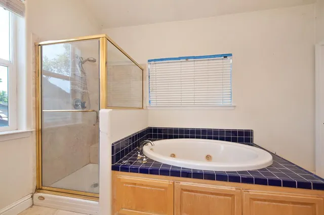 an empty room with a ceiling fan and a fan