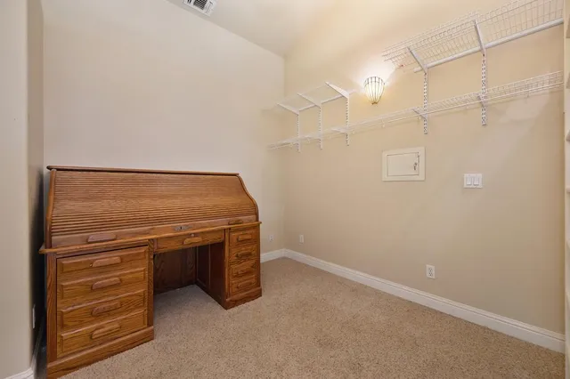 a view of a house with a table and chairs in patio
