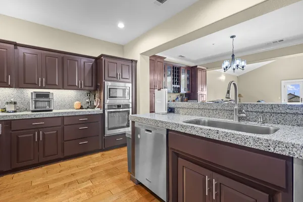 a kitchen with a sink stove and cabinets