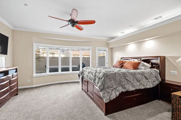 a bedroom with a bed and a large window