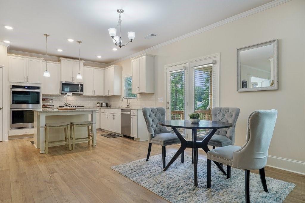 66 Snowdon Way Villa Rica, GA 30180 - Photo 12 of 52 a view of a dining room with furniture and wooden floor