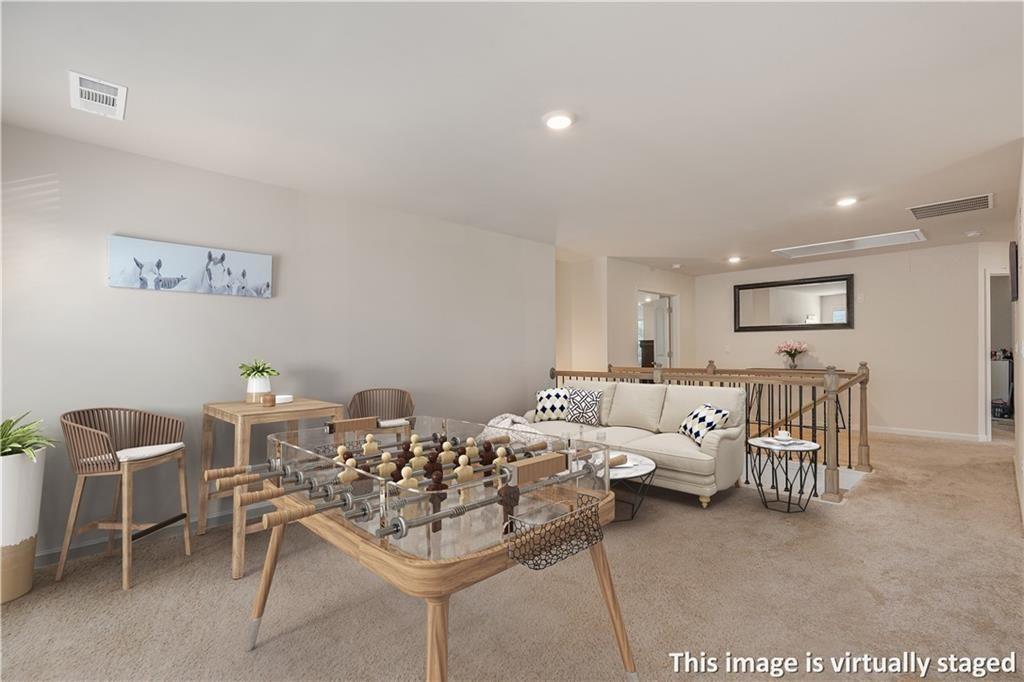 66 Snowdon Way Villa Rica, GA 30180 - Photo 26 of 52 a living room with furniture and a table