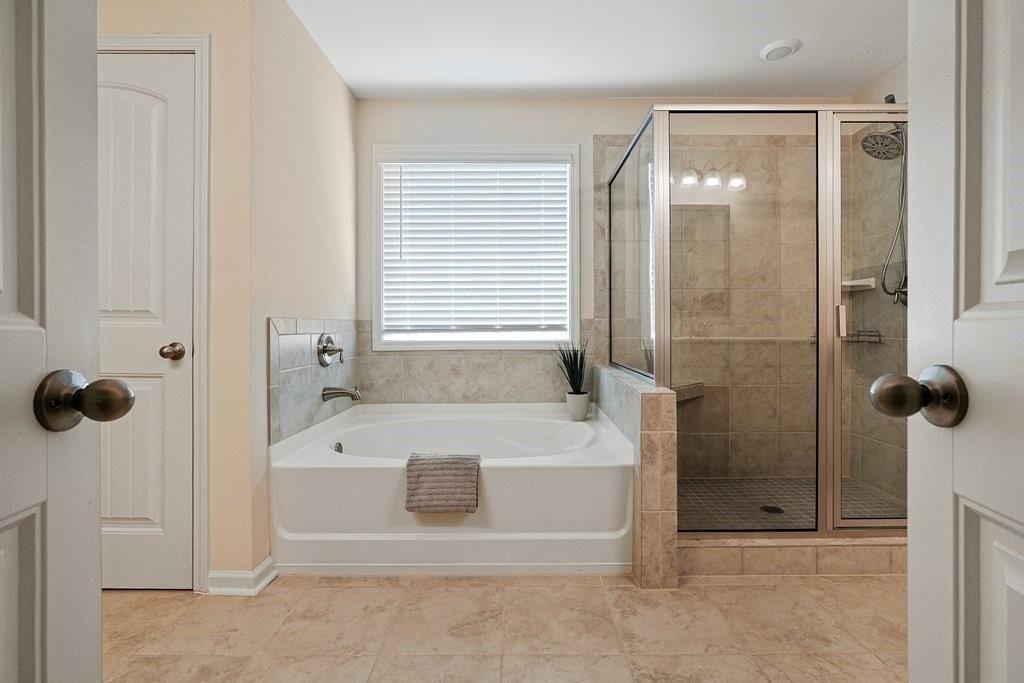 66 Snowdon Way Villa Rica, GA 30180 - Photo 37 of 52 a bathroom with a tub shower and a sink