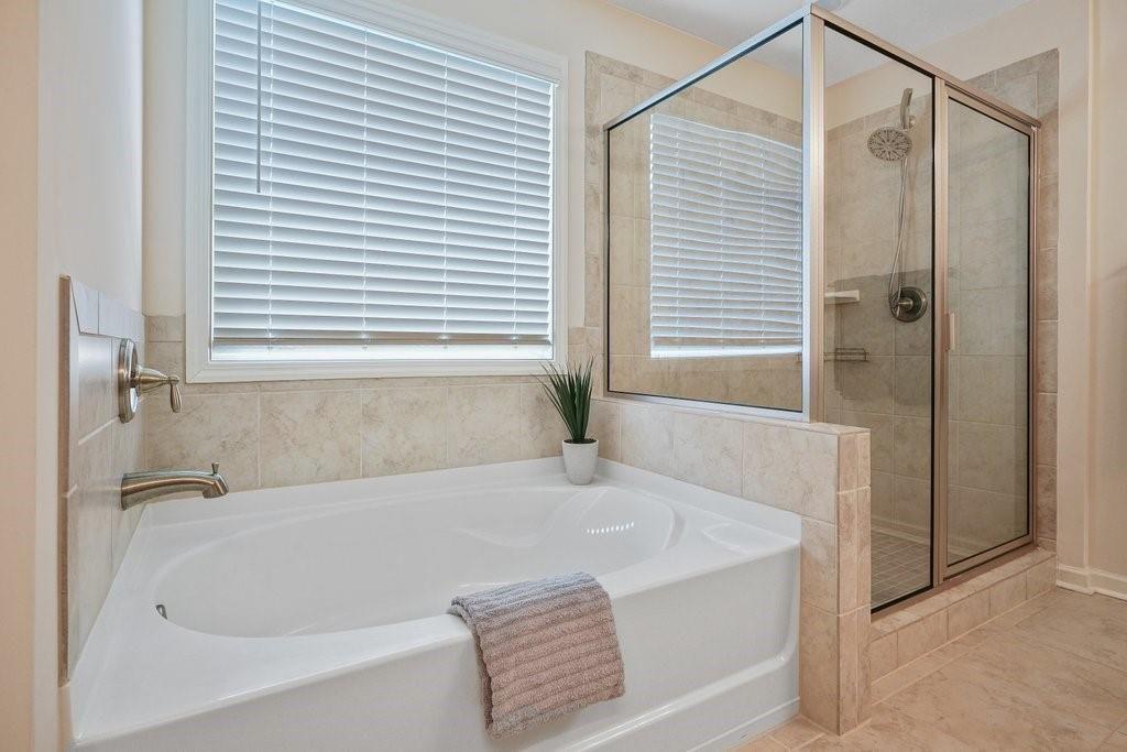66 Snowdon Way Villa Rica, GA 30180 - Photo 38 of 52 a bathroom with a bathtub and shower