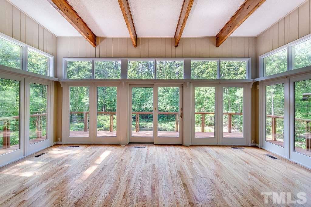 5401 Couch Mountain Road Durham, NC 27705 - Photo 11 of 25 The living room is spectacular! Stunningly beautiful and private view of your own private pond, wrap around deck that looks over floating dock and stone patio.