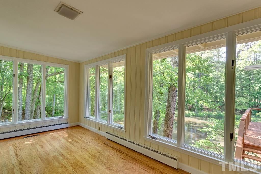 5401 Couch Mountain Road Durham, NC 27705 - Photo 13 of 25 This is the view that welcomes you as you step out of the master bedroom. The master suite sunroom is separated from the dining area by a pocket door.