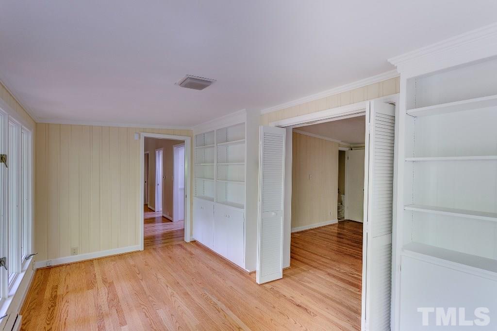 5401 Couch Mountain Road Durham, NC 27705 - Photo 14 of 25 This reverse angle of the master suite sunroom shows the door way back to the dining area, the built-in cabinets, shelving, and the double door entry to the master bedroom. Wow!