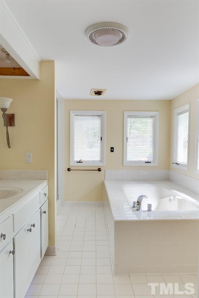 5401 Couch Mountain Road Durham, NC 27705 - Photo 16 of 25 Spacious master bath with oversized soaking tub, separate shower, double vanity and lots of space is luxurious and well appointed.