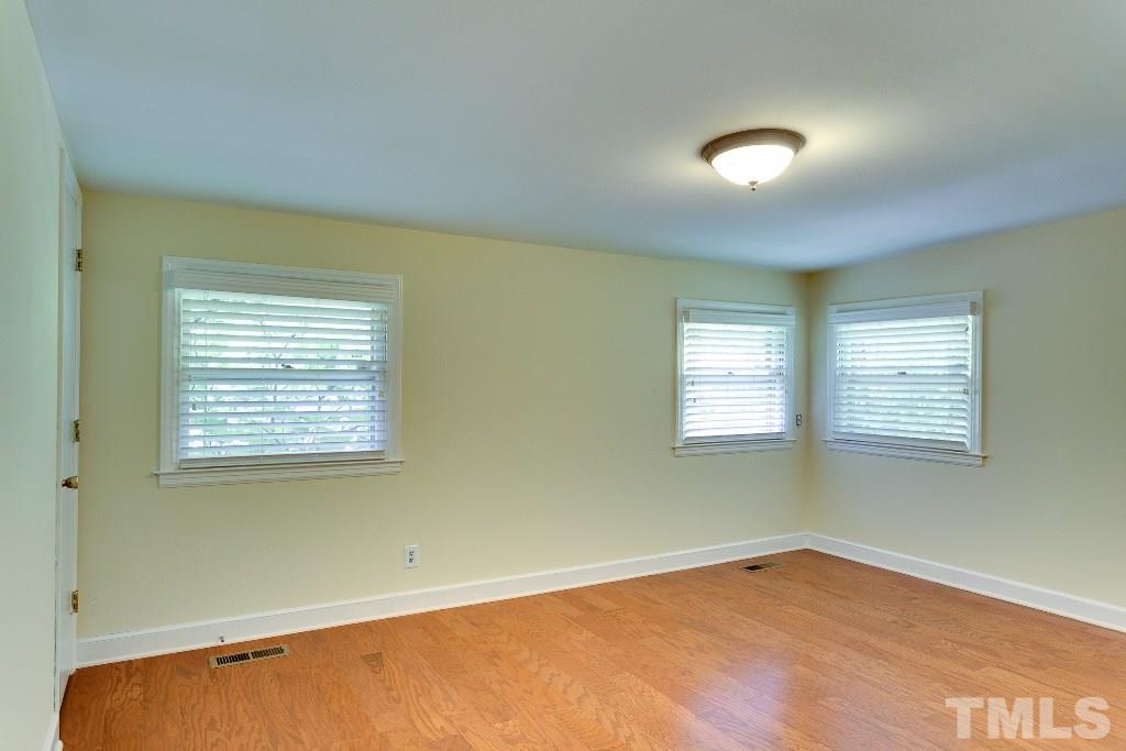 5401 Couch Mountain Road Durham, NC 27705 - Photo 17 of 25 Off the main hall on the other end of the house are the bedrooms. Bedroom two has two closets, three windows and lots of natural light.