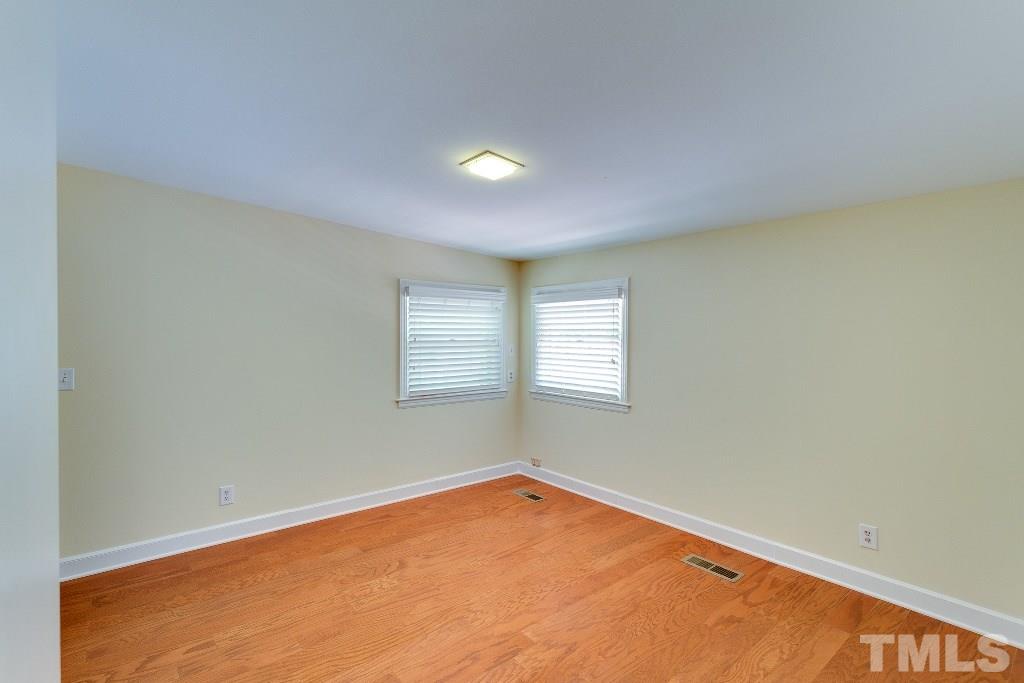 5401 Couch Mountain Road Durham, NC 27705 - Photo 18 of 25 Bedroom three is spacious with a double closet and two corner windows.