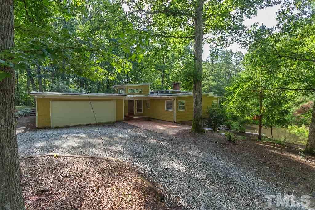 5401 Couch Mountain Road Durham, NC 27705 - Photo 2 of 25 The circular drive, 2 car garage and covered entry into the atrium foyer. The pond with floating dock can be seen on the right. Property boarders Duke Forest land preserve.