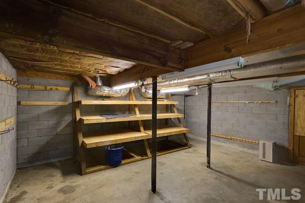 5401 Couch Mountain Road Durham, NC 27705 - Photo 22 of 25 This shows the large basement storage room/ workshop with windows and lighting.