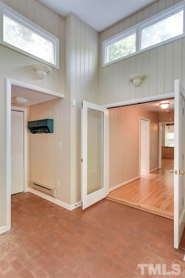 5401 Couch Mountain Road Durham, NC 27705 - Photo 4 of 25 There is a door to the garage out of sight on the left. There is a half bath and coat closet to the left and double doors into the main hall to the right.