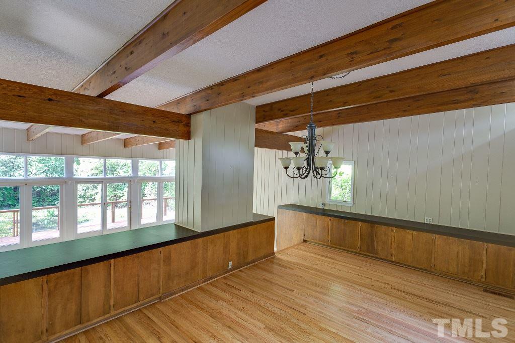5401 Couch Mountain Road Durham, NC 27705 - Photo 9 of 25 The dining area with beautiful exposed beams, built-in cabinets, beautiful hardwood floors and open to the sunken living room with panoramic view of private pond.