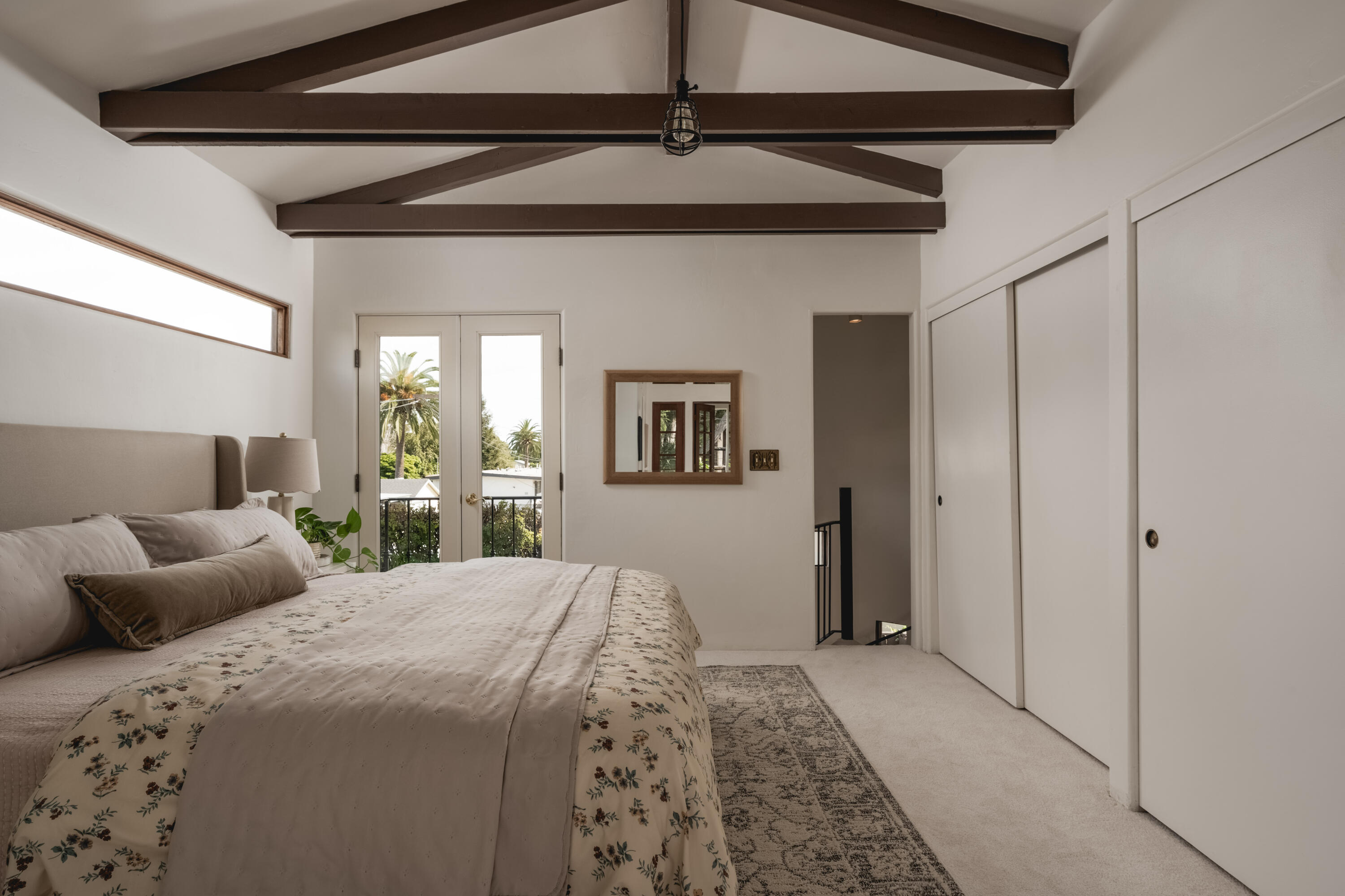 115 West Junipero Street Santa Barbara, CA 93105 - Photo 17 of 30 a bedroom with a bed and a chandelier