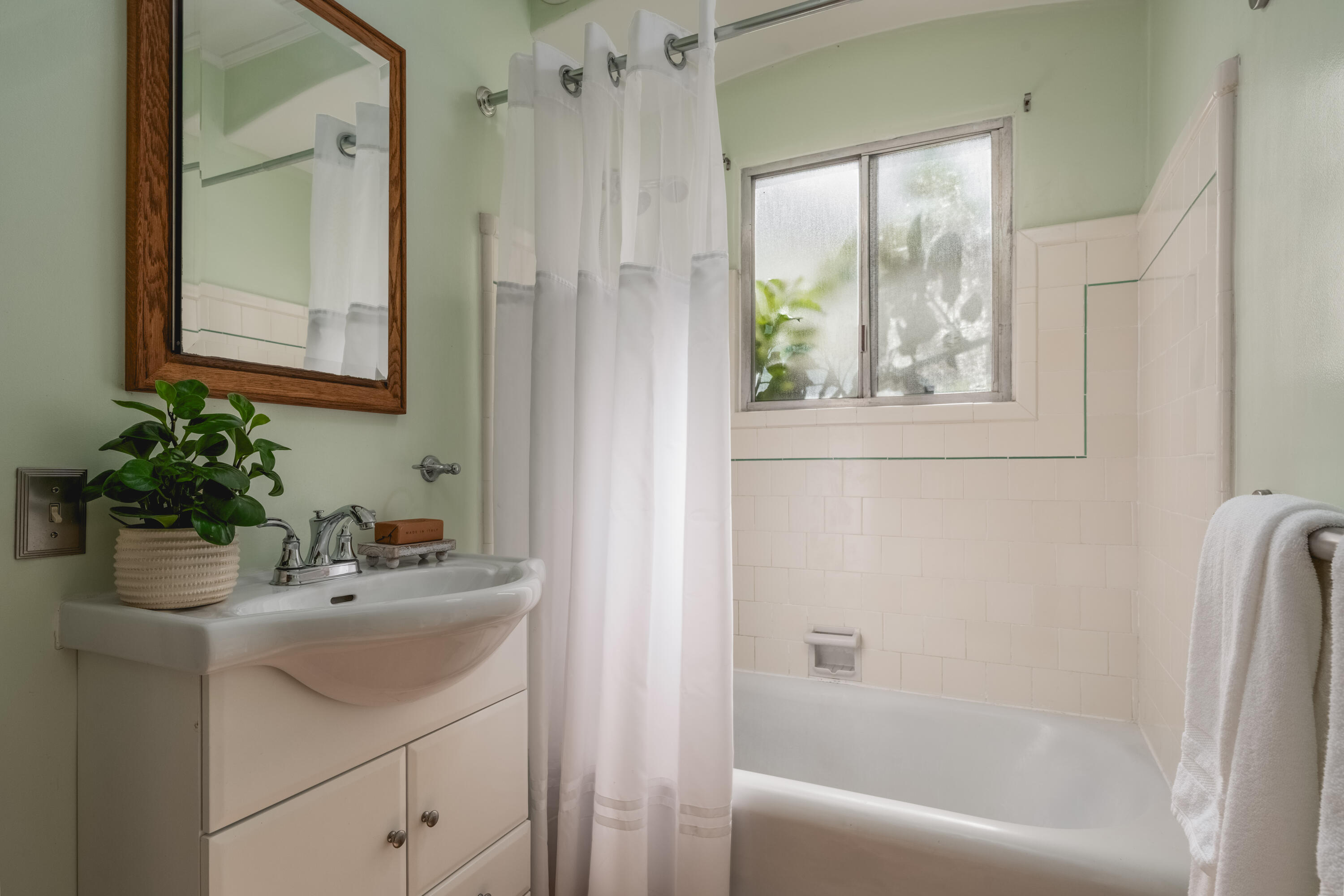 115 West Junipero Street Santa Barbara, CA 93105 - Photo 22 of 30 a bathroom with a sink a window and a mirror