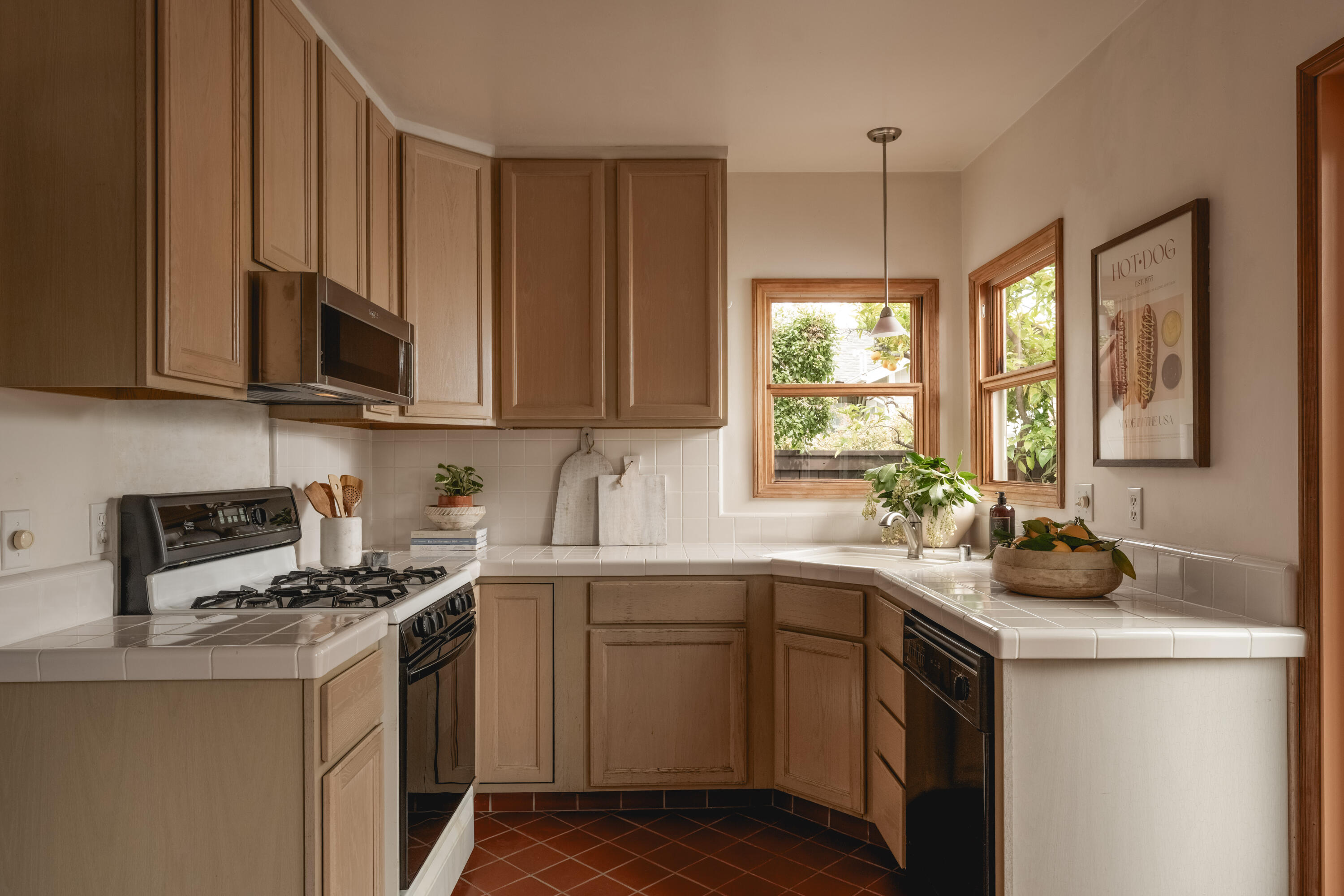 115 West Junipero Street Santa Barbara, CA 93105 - Photo 10 of 30 a kitchen with a sink stove and cabinets