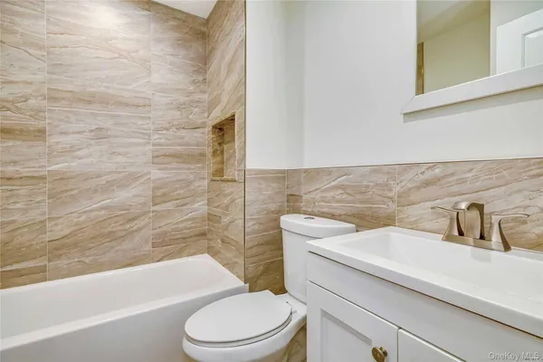 a bathroom with a sink a toilet and bathtub