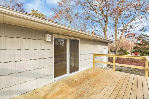 a view of a terrace with a bench and wooden floor