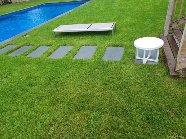 a view of a backyard with a table and chair