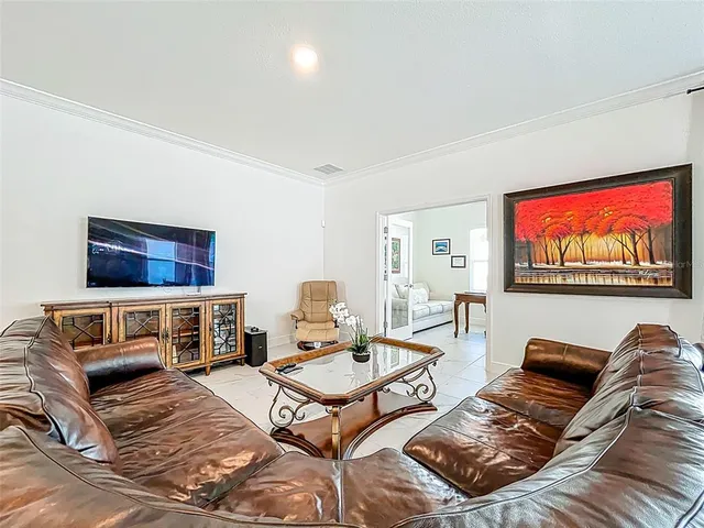 a living room with furniture a rug and a flat screen tv