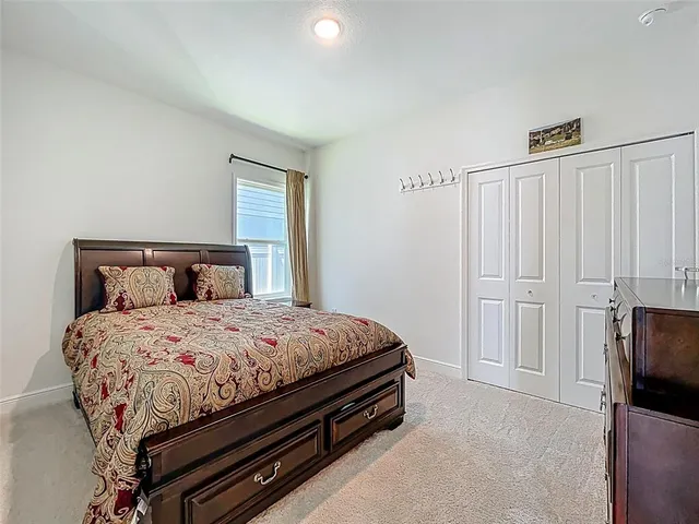 a bedroom with a bed and dresser