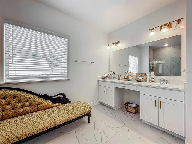 a bathroom with a granite countertop sink a mirror and a vanity