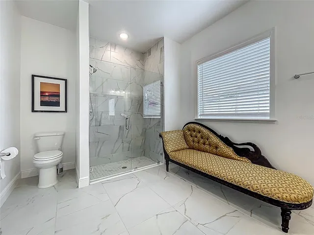 a front view of a house with a swimming pool and outdoor seating