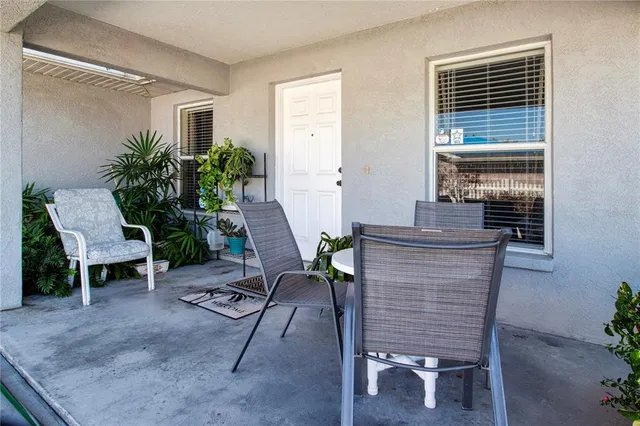 a living room with furniture and a dining table