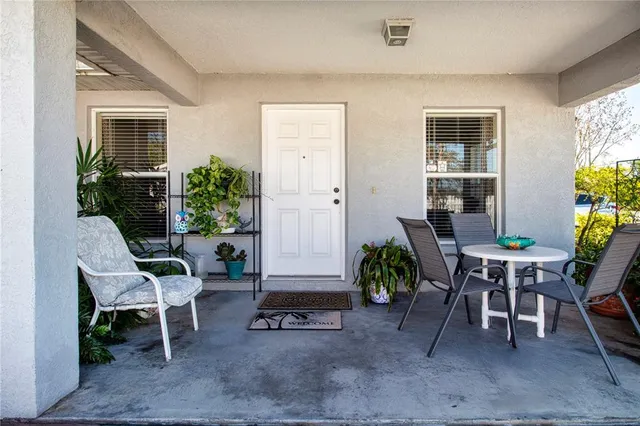a living room with furniture and a dining table