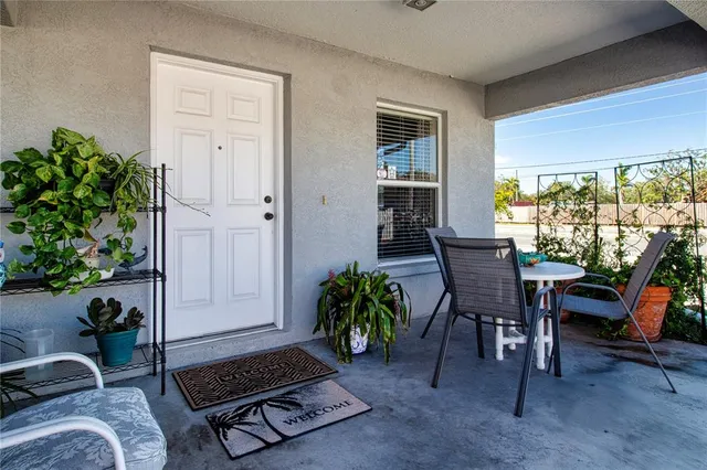 a living room with furniture and a dining table