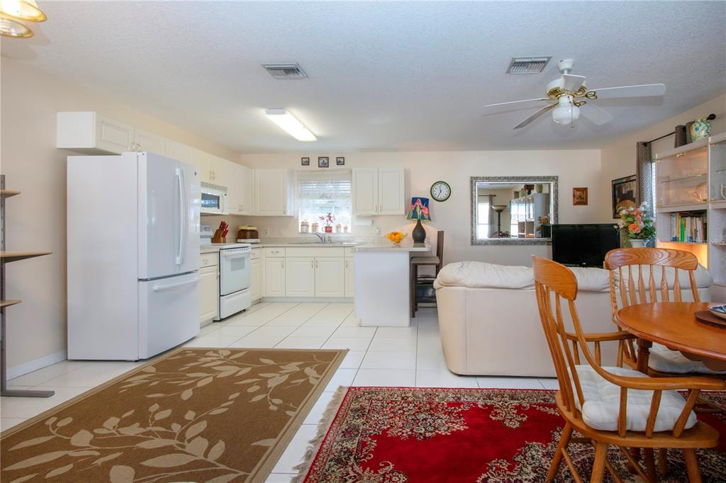 4010 North Lockwood Ridge Road Sarasota, FL 34235 - Photo 14 of 64 a kitchen with stainless steel appliances granite countertop a refrigerator sink and white cabinets