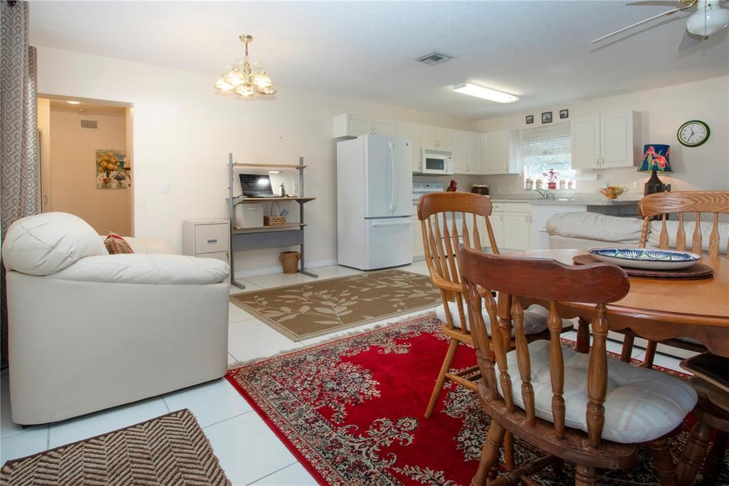 4010 North Lockwood Ridge Road Sarasota, FL 34235 - Photo 16 of 64 a living room with furniture a dining table and kitchen view