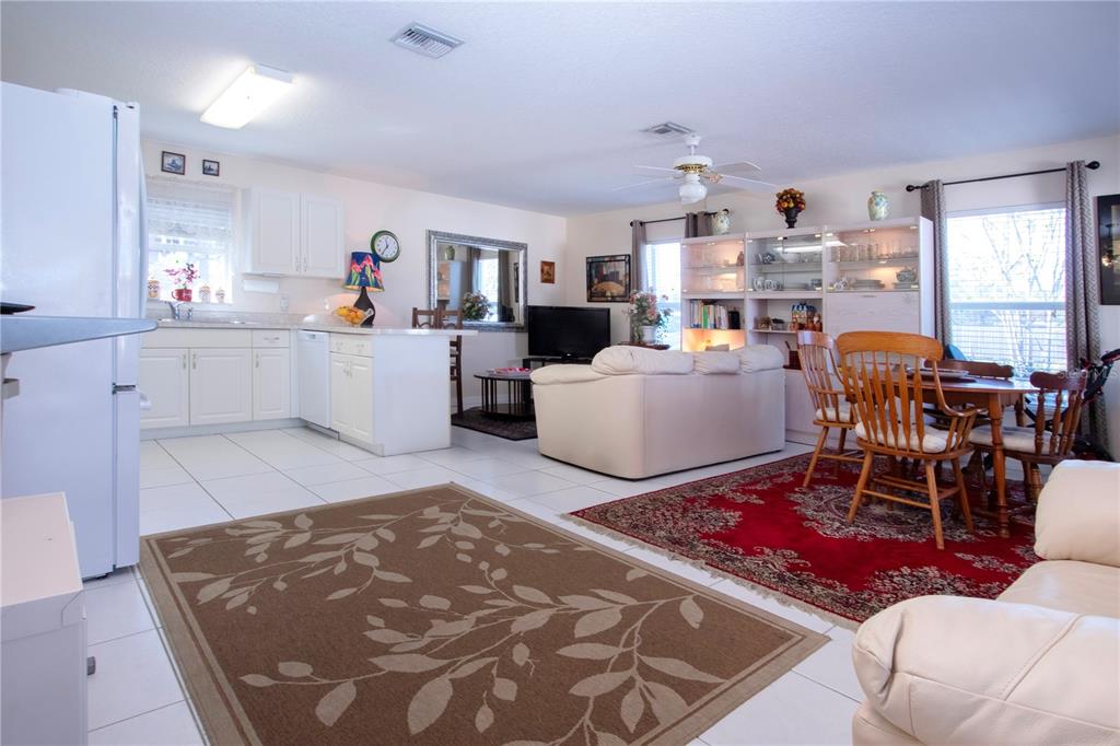 4010 North Lockwood Ridge Road Sarasota, FL 34235 - Photo 17 of 64 a living room with furniture and a dining table