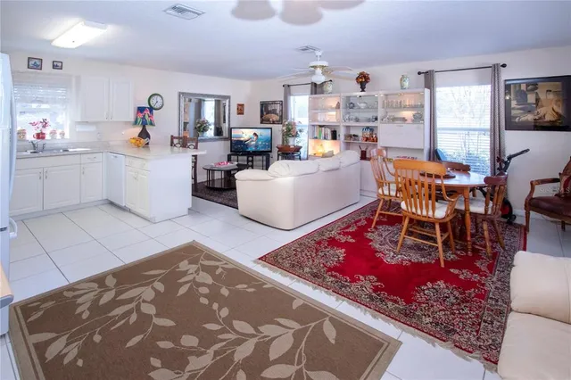 a living room with furniture a dining table and a fireplace