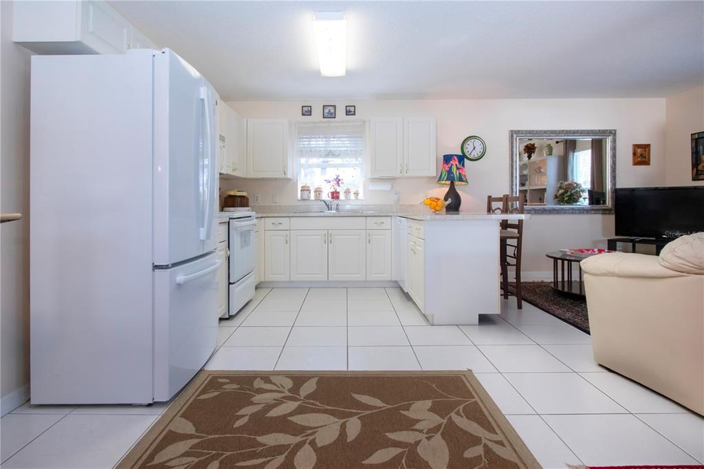 4010 North Lockwood Ridge Road Sarasota, FL 34235 - Photo 21 of 64 a room with a white cabinets and white appliances
