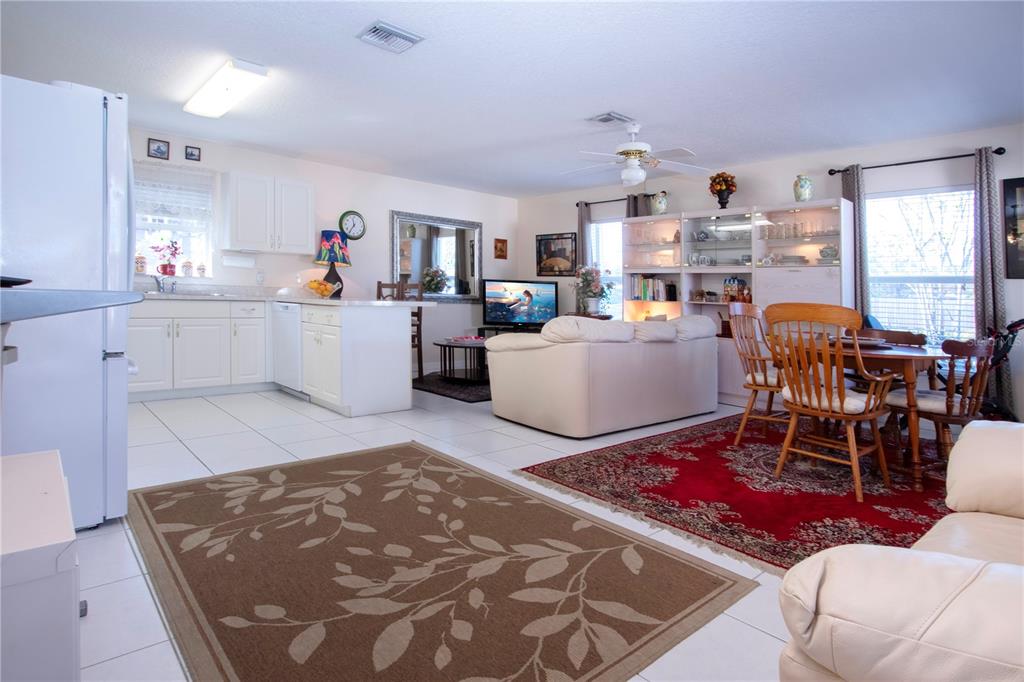 4010 North Lockwood Ridge Road Sarasota, FL 34235 - Photo 22 of 64 a living room with furniture and a kitchen view