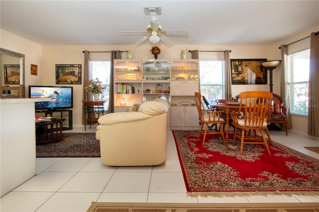 4010 North Lockwood Ridge Road Sarasota, FL 34235 - Photo 27 of 64 a living room with furniture a dining table and a fireplace