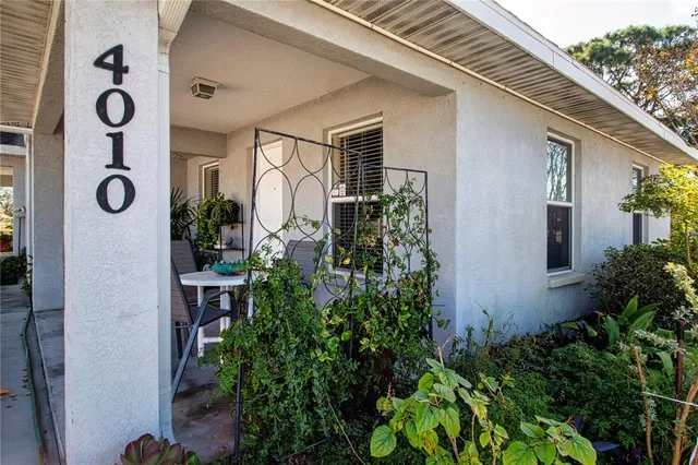 an aerial view of a house with swimming pool and patio