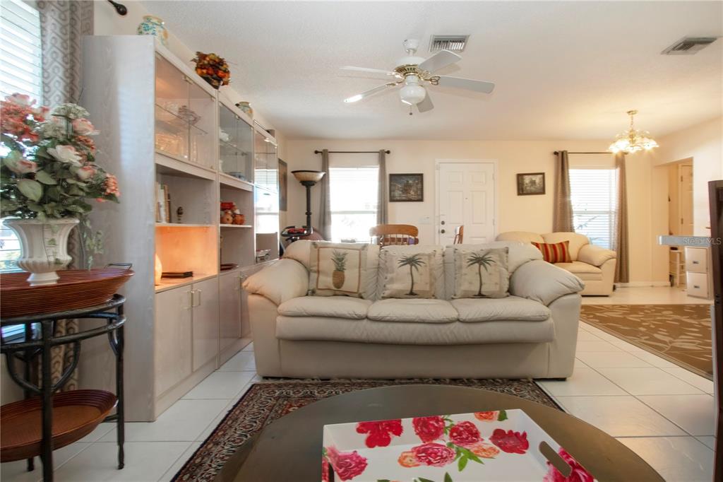 4010 North Lockwood Ridge Road Sarasota, FL 34235 - Photo 32 of 64 a living room with furniture and a chandelier