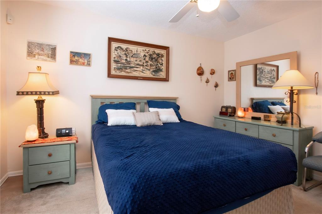 4010 North Lockwood Ridge Road Sarasota, FL 34235 - Photo 38 of 64 a bedroom with a bed and a lamp on dresser