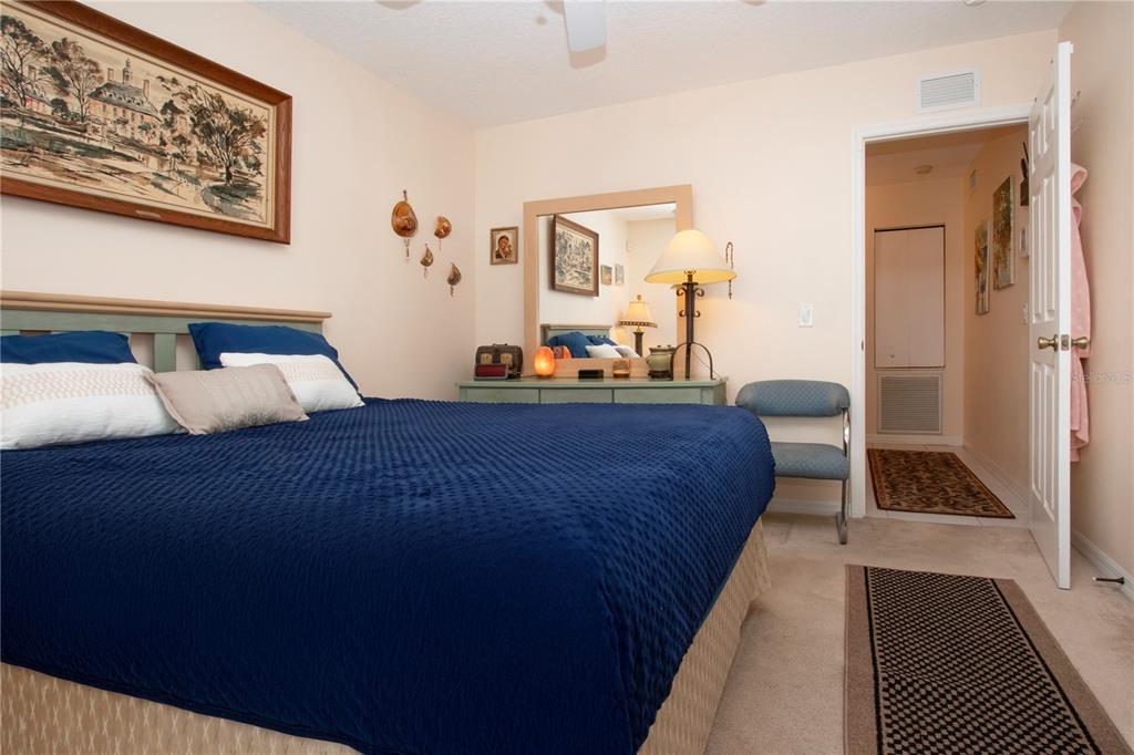 4010 North Lockwood Ridge Road Sarasota, FL 34235 - Photo 39 of 64 a bedroom with bed and cabinet